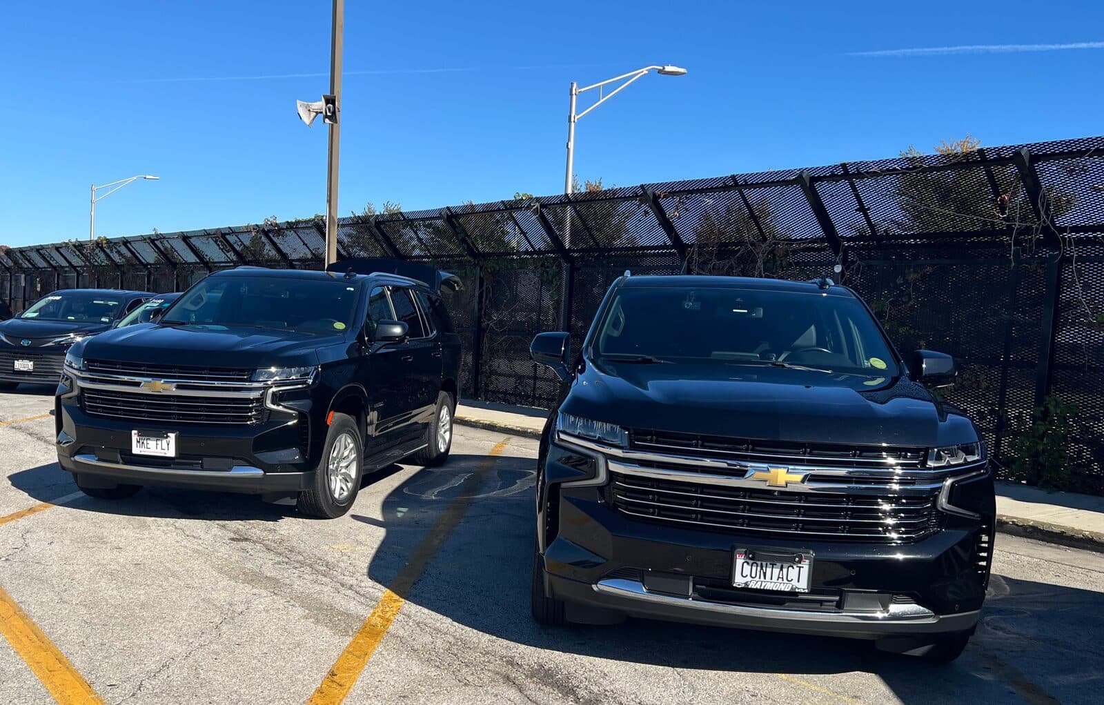 Contact Limo LLC two-vehicle fleet in O'Hare Airport parking area — point-to-point transfer service Kenosha to ORD