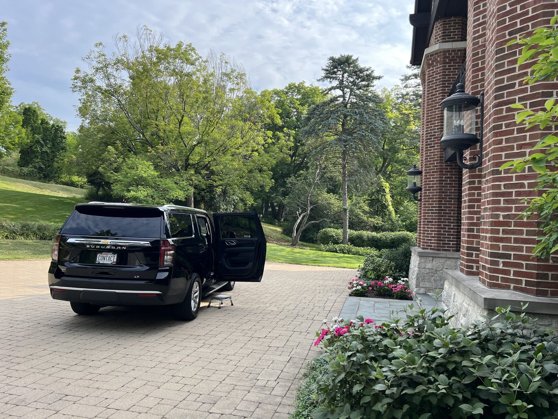 Contact Limo SUV door open at estate pickup hourly charter service Wisconsin