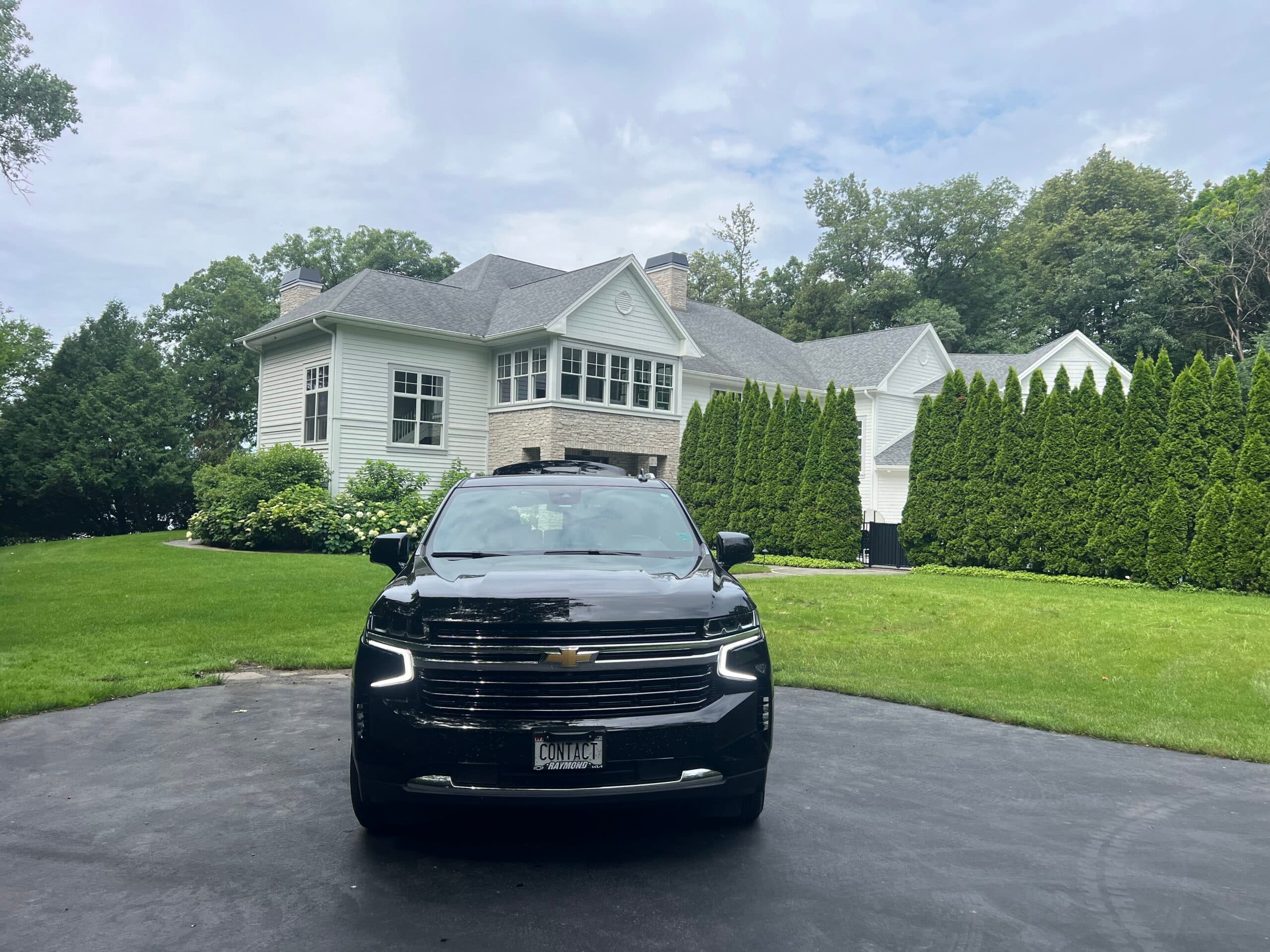 Contact Limo LLC luxury SUV front view at Elkhorn WI estate — golf and event limo service