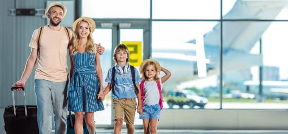 Family of four with luggage at airport terminal, Contact Limo airport transfer service Kenosha Wisconsin